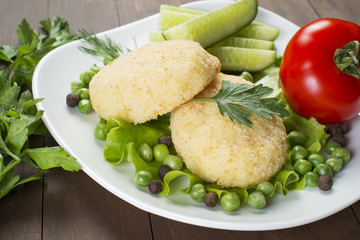 Potato patties with tomato, cucumber, green peas