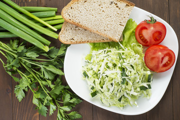 Cabbage salad with cucumber, tomatoes and herbs