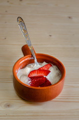 Cottage cheese with strawberries in a ceramic bowl