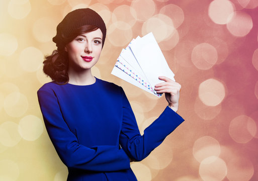 women in blue dress with envelopes