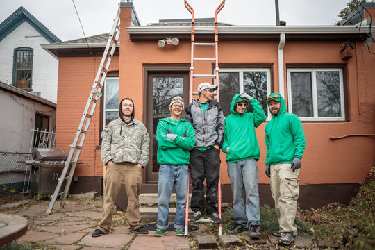 Solar panel installation crew outside a house