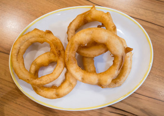 fried onion rings on white plate