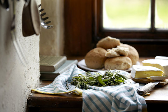 Bread rolls and brie on kitchen counter