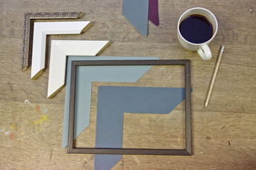 Still life of frames and coffee in picture framers workshop