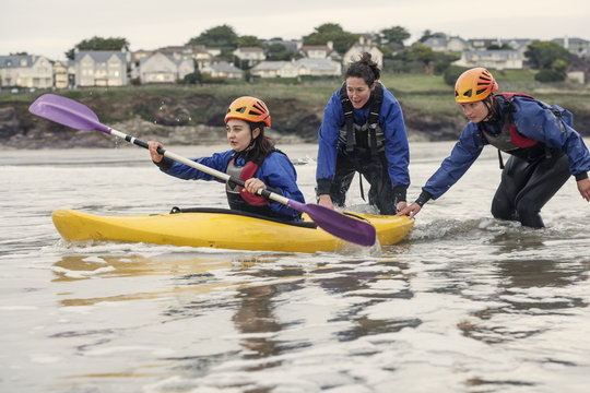 Woman learning how to sea kayak, Cornwall, England