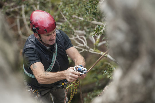 Male rock climber using carabiner