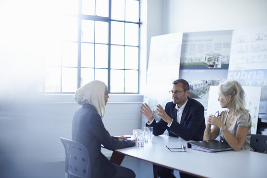 Business team discussing presentation ideas in conference room