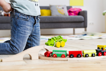 Girl playing with toy cars at home