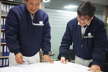 Workers looking at ship plans, GoSeong-gun, South Korea