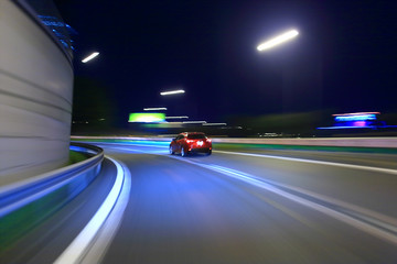 Car driving on highway at night