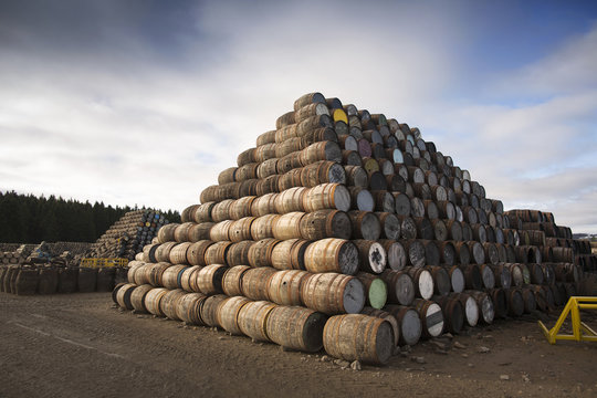 Pile of wooden barrels outside
