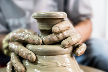 Clay potter creating on the pottery wheel