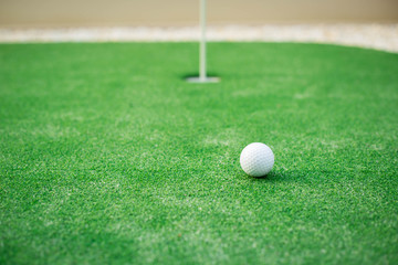 golf ball close to the hole