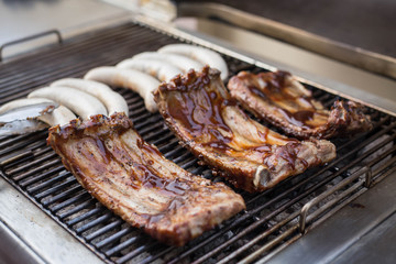 Grilled pork rip and sausage on the stove