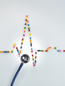 Acoustic stethoscope and electrocardiogram of a human heart made up of medicine