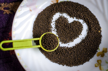 Love tea tea grains in tea spoon and plate
