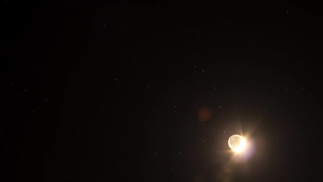 A moon for the sky with the stars  moving along with the rotation of the Earth. time lapse