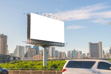 large blank billboard on road with city view background