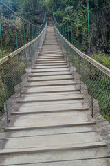 Suspension bridges leading to the viewpoint on Pailon del Diablo (Devil's Cauldron) waterfall near Banos town, Ecuador