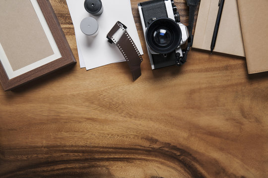 camera and supplies, Blank photo frames on wooden table