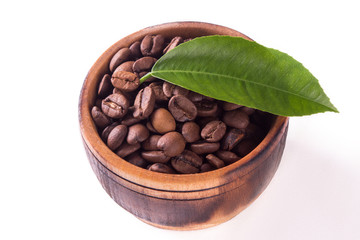 coffee grains and leaves in a wooden bowl