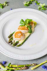 Freshly sauteed scallops with green asparagus