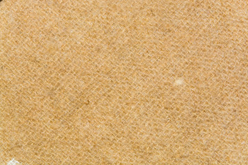 The texture of light brown twisted woolen threads closeup