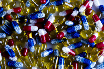 Drug prescription for treatment medication. Pharmaceutical medicament, cure in container for health. Pharmacy theme, Heap of red orange white round capsule pills with medicine antibiotic in packages.