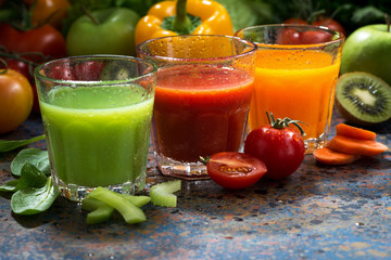 assortment of vegetable juices on a blue background, closeup