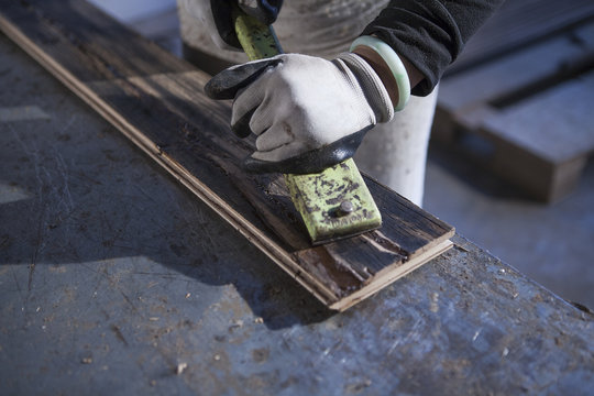 Carpenter working on wood plank in factory, Jiangsu, China