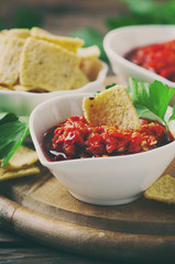 Hot mexican salsa with chili peppers and chips