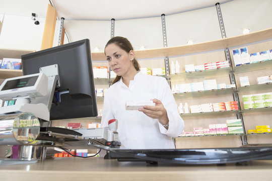 Pharmacist in pharmacy using computer