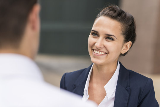 Young businesswoman and man chatting, London, UK