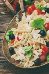 Salad with cold pasta, basil and mozzarella