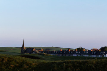 View across a golf course to the church behind