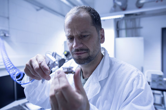 Lab assistant fixing part