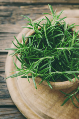 Aromatic fresh rosemary on the wooden table