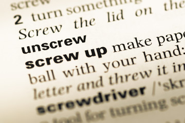 Obraz premium Close up of old English dictionary page with word unscrew