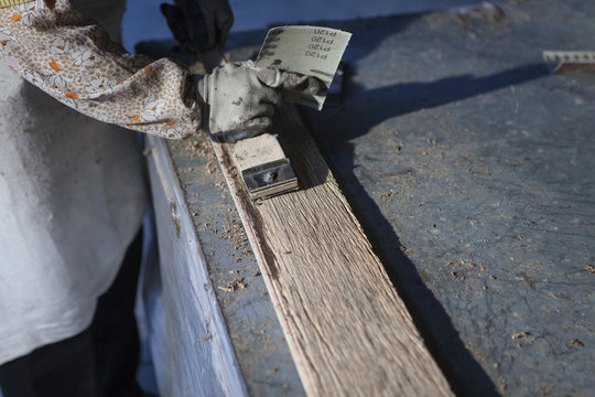 Carpenter working on wood plank in factory, Jiangsu, China