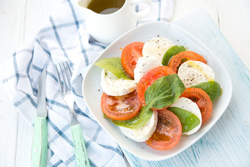 Fresh salad with tomatoes, a mozzarella and a basil