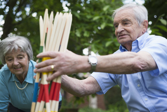 Grandfather and grandmother with giant pick up sticks