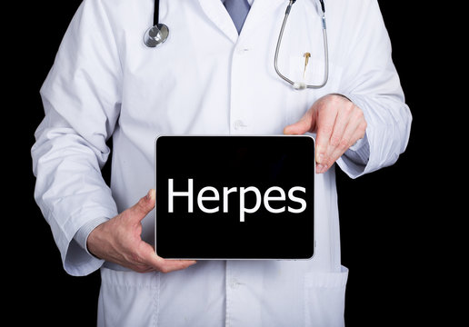 technology, internet and networking in medicine concept - Doctor holding a tablet pc with herpis sign. Internet technologies in medicine