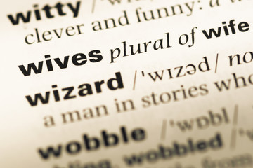 Obraz premium Close up of old English dictionary page with word wives