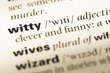 Close up of old English dictionary page with word witty