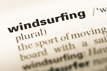 Close up of old English dictionary page with word windsurfing