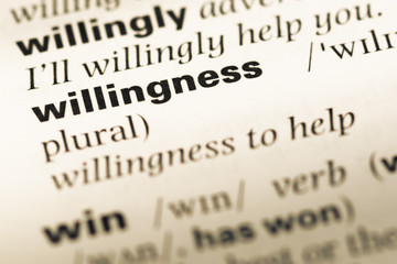 Close up of old English dictionary page with word willingness