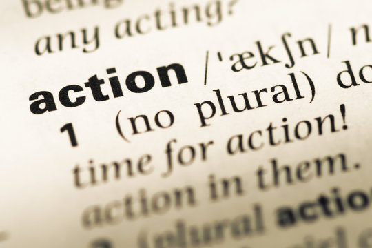 Close up of old English dictionary page with word action