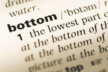 Obraz premium Close up of old English dictionary page with word bottom