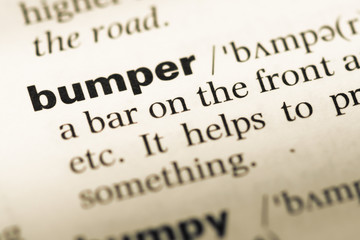 Obraz premium Close up of old English dictionary page with word bumper