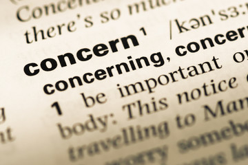 Obraz premium Close up of old English dictionary page with word concern